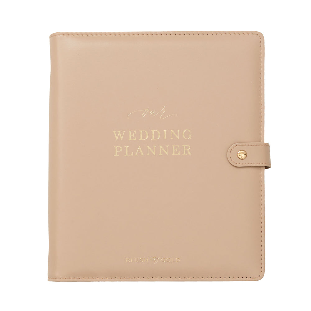Flat lay product shot of a nude leather wedding planner binder with gold foil lettering and snap closure on a white background