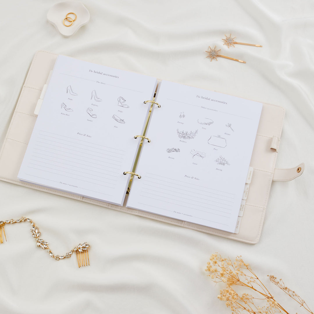 Open wedding planner binder showing bridal accessories pages with illustrated shoe styles on the left and other accessories including earrings and headpiece on the right
