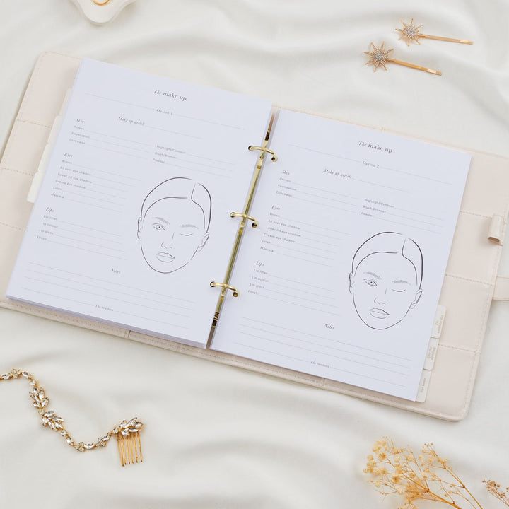 Open wedding planner binder showing two bridal makeup planning pages with face chart line illustrations and product fields for skin, eyes and lips