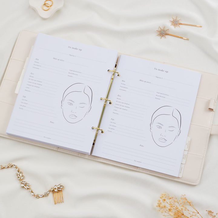 Open wedding planner binder showing two bridal makeup planning pages with face chart illustrations and product fields
