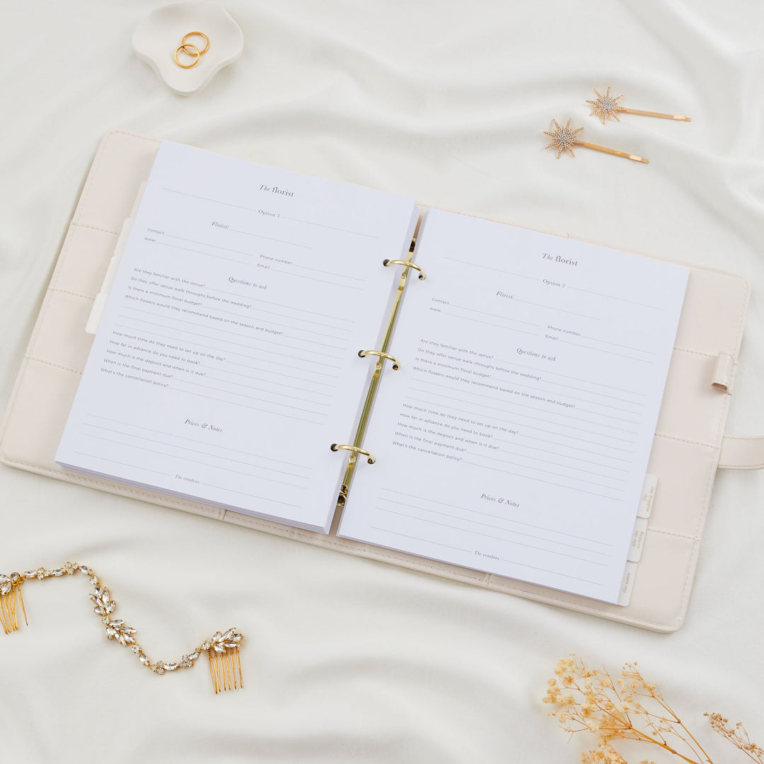 pen wedding planner binder showing two florist comparison pages with contact details, questions to ask and prices and notes sections styled with bridal accessories flatlay
