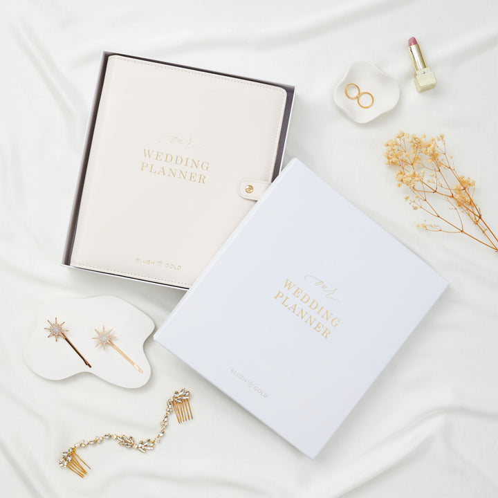Blush and Gold wedding planner binder in gift box shown in ivory and white versions alongside bridal hair accessories