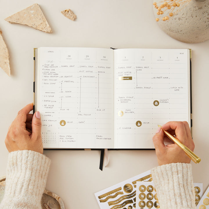 2025 weekly planner with minimalist floral design, gold foil details, and gold edging, offering weekly layouts for time blocking, to-do lists, and notes.